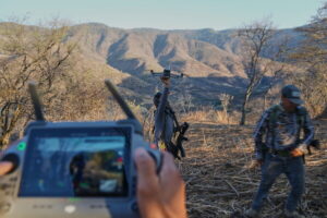 Members of a local self-defense group formed by residents in response to cartel violence fly a drone in Guajes de Ayala, Mexico, Tuesday, March 10, 2026. (AP Photo/Marco Ugarte)