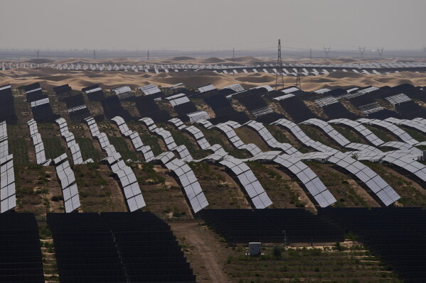 Solar panels operate at the Dalad Banner Photovoltaic Top Runner Base in northern China's Inner Mongolia province on Friday, June 12, 2026. (AP Photo/Ng Han Guan)
