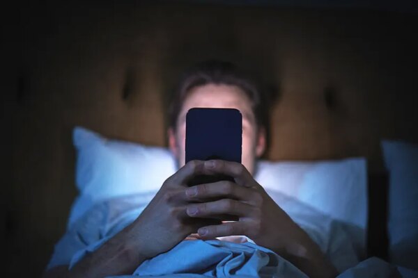 Anonymous Man Uses Smartphone in Bed
