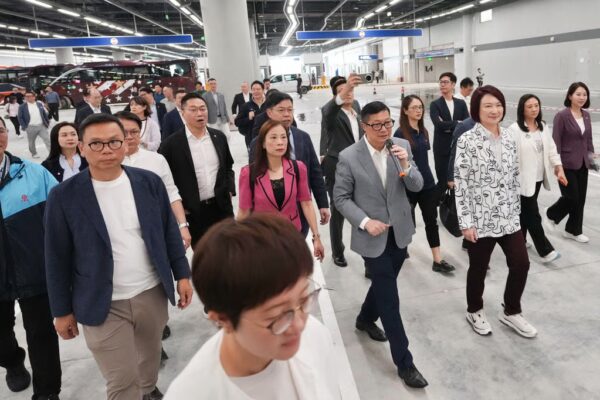 Secretary for Security Chris Tang (centre, holding microphone) participates in a press and lawmaker tour of the newly revamped Huanggang Port facility. Photo: Karma Lo