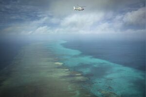 A Chinese Navy helicopter flies above Scarborough Shoal in the South China Sea