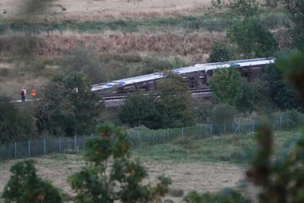 Passenger train derails and 11 people injured after carriages overturn in southern England