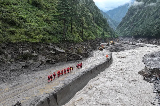 Firefighters conduct search and rescue operations after a mudslide in Gyirong county