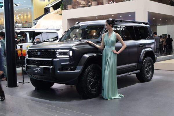 A Chery Zongheng G700 off-road SUV on display at the 2026 Beijing auto show, with a model standing beside the vehicle.