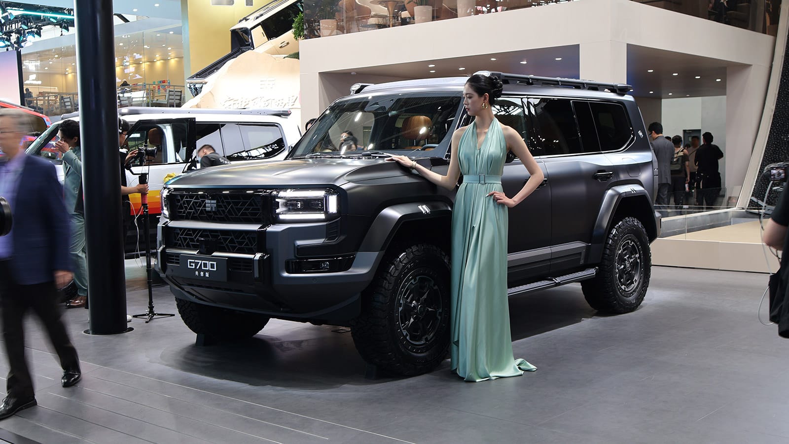 A Chery Zongheng G700 off-road SUV on display at the 2026 Beijing auto show, with a model standing beside the vehicle.
