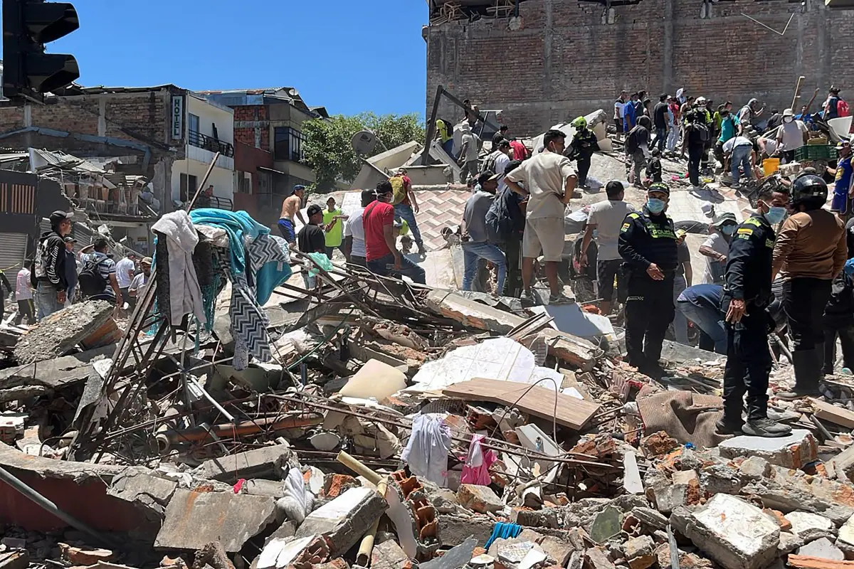 Rescuers look for survivors at a collapsed building after an earthquake in Pereira