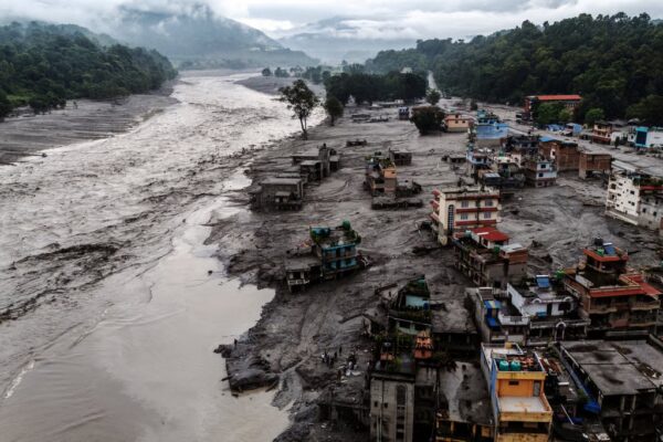 A drone view shows damaged buildings and mud-covered houses next to the Likhu River following deadly flash floods and mudslides in Devighat, in Nepal’s Nuwakot district, on Wednesday. Photo: Reuters