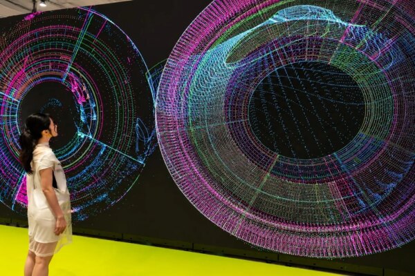A visitor views Kim Asendorf’s visual LED screens at Art Basel Hong Kong. (Image: Nguyen Wahed/Kim Asendorf) 

