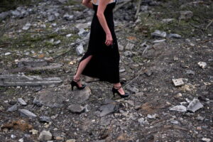 A woman walks across the debris in the aftermath of an overnight Russian missile and drone attack on Kyiv, Ukraine, Thursday, Aug. 20, 2026 (AP Photo/Francisco Seco)