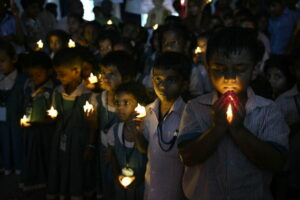 TOPSHOT - School students hold LED candles as they gather to pay their homage to people who died in Nepal's flash flood, in Chennai on August 28, 2026. (Photo by R. Satish BABU / AFP via Getty Images)