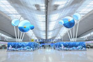 The departure hall at Hong Kong International Airport’s newly revamped Terminal 2 features large LED screens with ocean-themed displays. Photo: Airport Authority Hong Kong