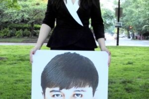 Rayhan Asat holds a picture of her brother, Ekpar, who went missing in 2016 after returning to Xinjiang from a trip to Washington, D.C., following participation in the State Department's International Visitor Leadership Program.
