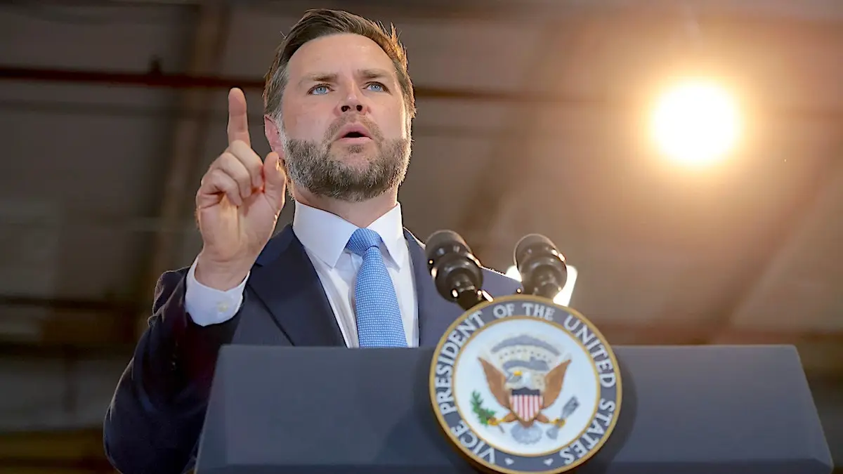 Vice President JD Vance speaks at a podium at CompoTech headquarters in Brewer, Maine.