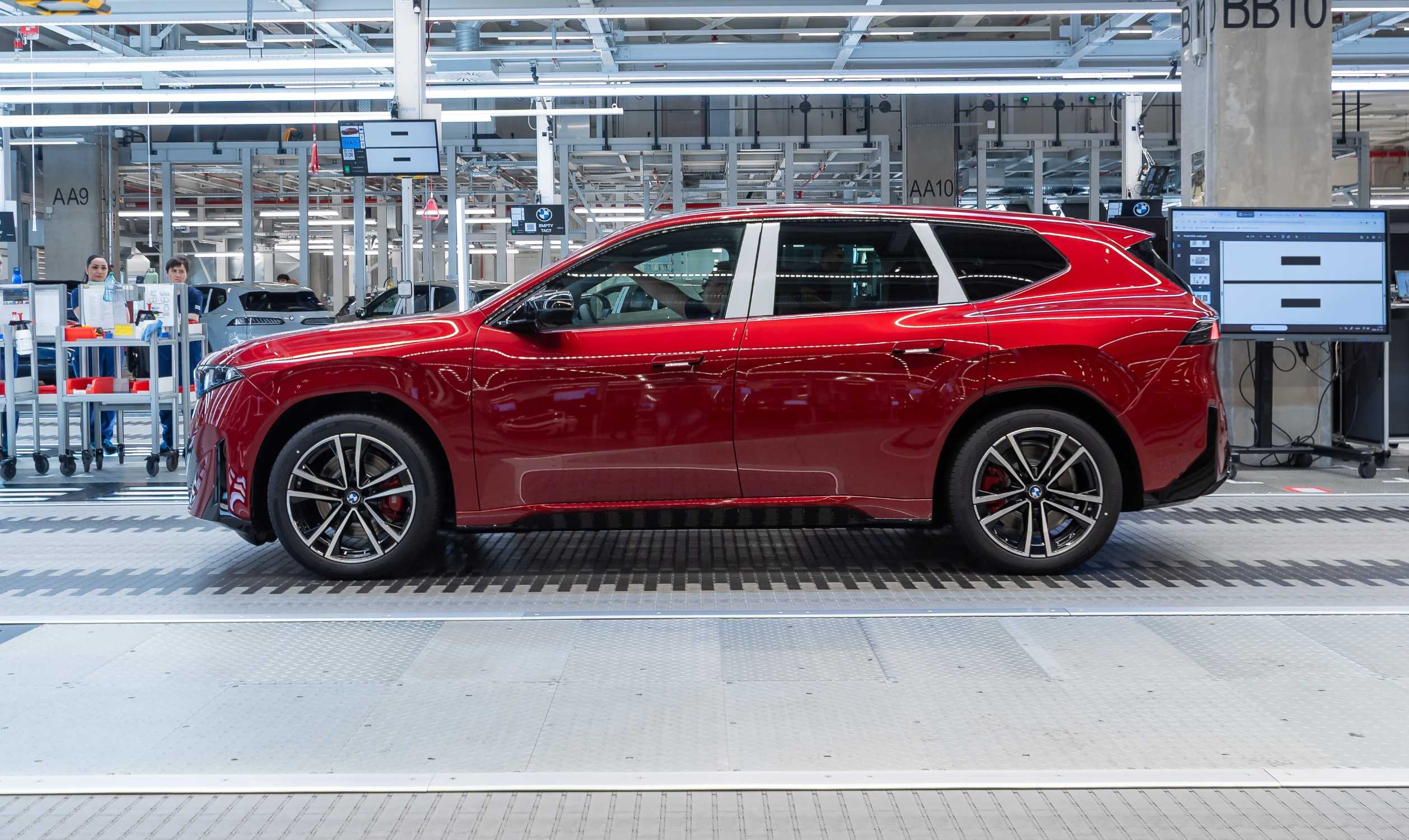 A red BMW iX3 moves down the assembly line at BMW Group Plant Debrecen, where series production of the Neue Klasse iX3 began