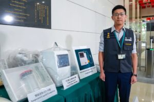Senior investigator Chan Kit-lun of the Customs and Excise Department’s drug investigation bureau displays the seized production equipment, which could produce up to 160,000 etomidate cartridges in a short period. Photo: Sam Tsang