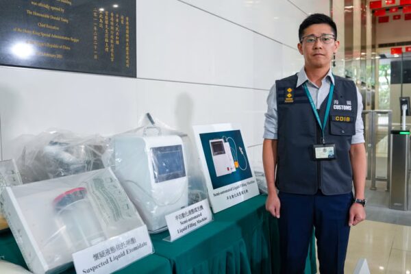 Senior investigator Chan Kit-lun of the Customs and Excise Department’s drug investigation bureau displays the seized production equipment, which could produce up to 160,000 etomidate cartridges in a short period. Photo: Sam Tsang