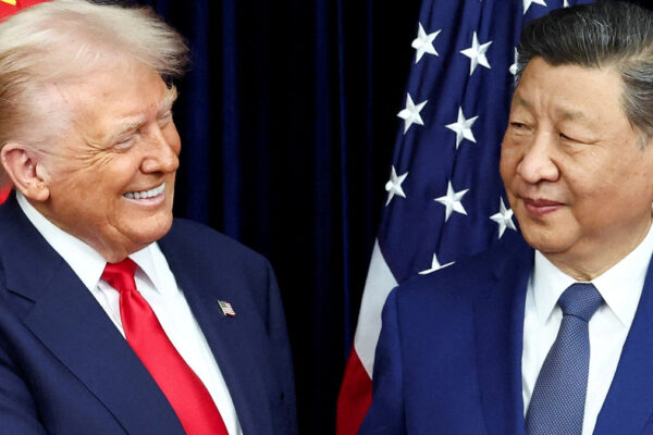 FILE PHOTO: U.S. President Donald Trump and Chinese President Xi Jinping react as they hold a bilateral meeting at Gimhae International Airport, on the sidelines of the Asia-Pacific Economic Cooperation (APEC) summit, in Busan, South Korea, October 30, 2025. REUTERS/Evelyn Hockstein/File Photo