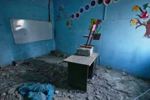 Colourful tree and flower decorations remain on the walls of a rubble-strewn classroom at Shajareh Tayyebeh school, damaged in a U.S. airstrike on February 28, in Minab, southern Iran. (AP Photo)