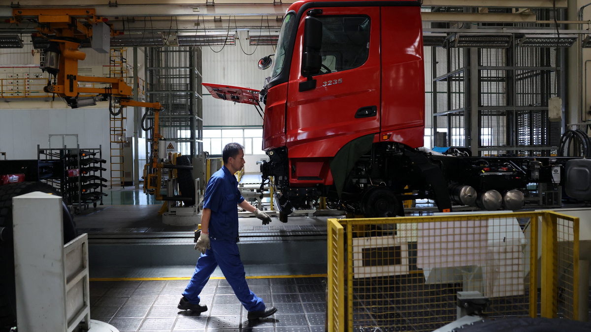 An employee walks at the truck assembly line at Beiben Trucks Group factory during an organized media tour, in Baotou, Inner Mongolia Autonomous Region, China, June 13, 2026. REUTERS/Maxim Shemetov