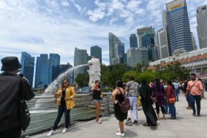 People gather next to the Merlion statue at the Marina Bay waterfront in Singapore. Photo: AFP