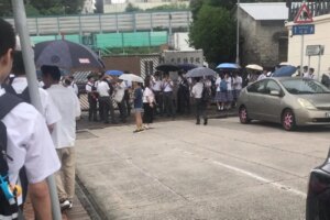 Education Bureau steps in after students wait in rain for uniform and hair checks