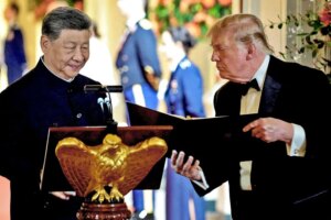 US President Donald Trump holds a binder as he stands next to Chinese President Xi Jinping before Xi delivers a speech during a state dinner at the White House in Washington, D.C., US, September 24, 2026.