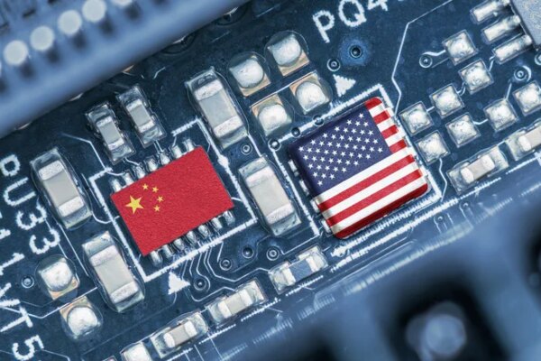 Flag of USA and China on a processor, CPU or GPU microchip on a motherboard. US companies have become the latest collateral damage in US - China tech war. US limits, restricts AI chips sales to China.