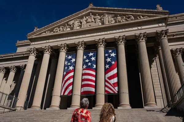 People stand in front of the National Archives Museum in Washington, D.C.