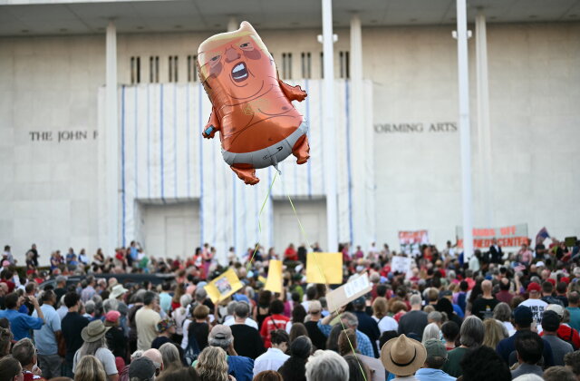 TOPSHOT - A balloon depicting US President Donald Trump is seen flying as people gather during a rally in support of the Kennedy Center in Washington, DC, on September 18, 2026. (Photo by Kent NISHIMURA / AFP via Getty Images)